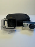 Silver GoPro HERO4 action camera in clear waterproof housing, black front screen