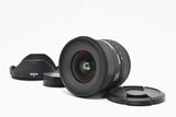 Black Sigma camera lens with lens hood and front cap