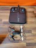 Black quadcopter drone with four propellers and handheld remote controller