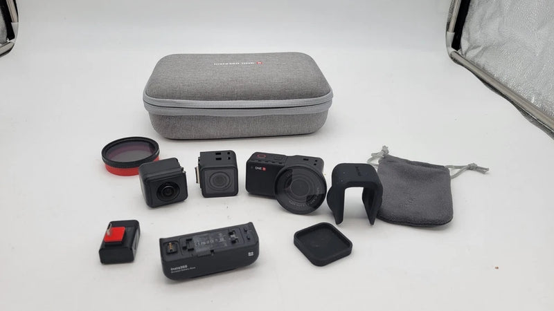 360 action camera bundle with black camera module, lens, straps, and gray hard case