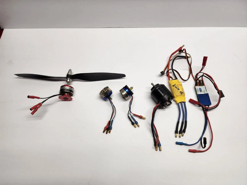 Brushless drone motor and ESC components with wiring harness and connectors.