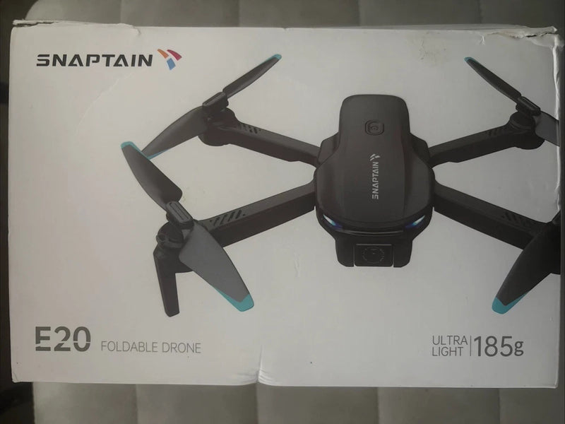 Foldable ultra-light drone with four propellers and blue tips, in retail box
