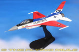 Red and white F-16 model jet with U.S. Air Force markings on black stand