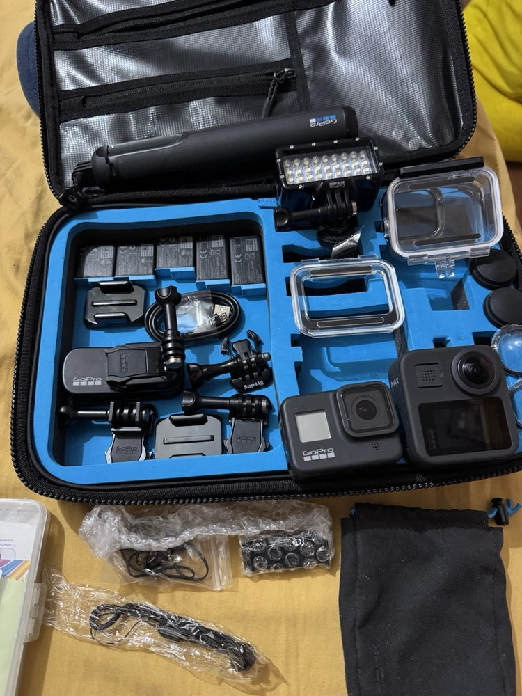 GoPro action camera bundle in zip case: multiple cameras, mounts, batteries, housings