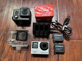 GoPro HERO4 silver action camera kit with waterproof housing, mounts, and batteries
