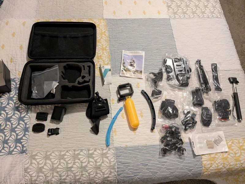 Black action camera accessory kit with open hard case, mounts, and storage pouch