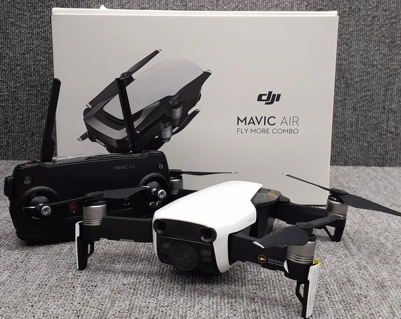 Foldable white and black quadcopter drone with remote controller