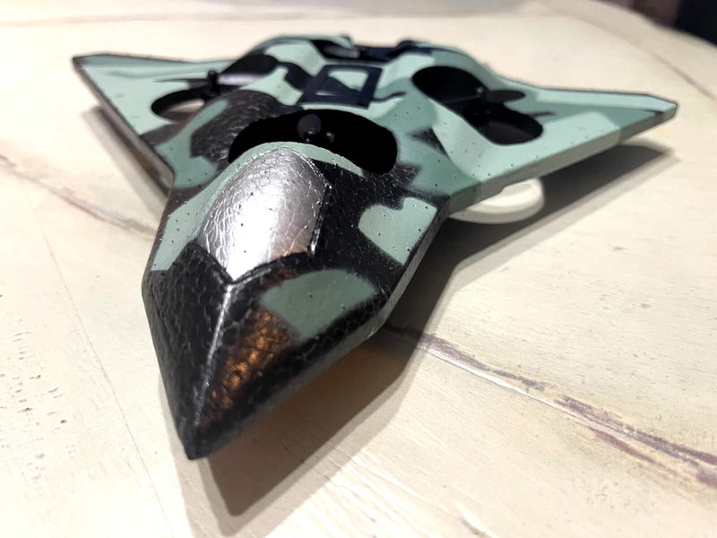 Green camo beginner quadcopter drone body with four motor mounts, LED accents