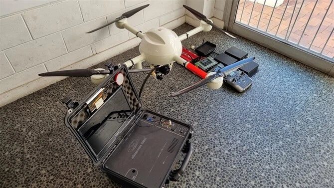 Quadcopter drone with remote controller and tablet in open carrying case