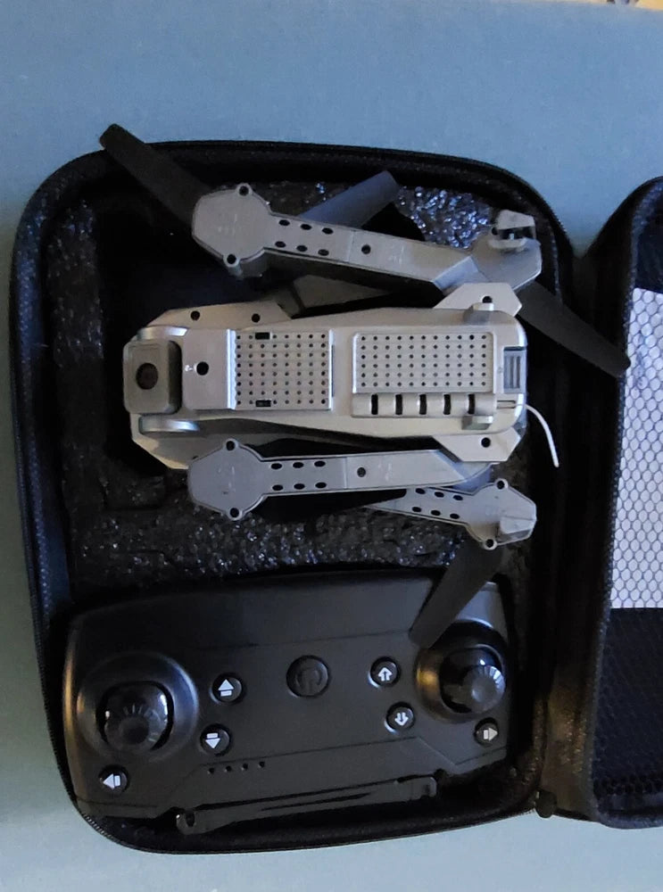 Collapsible quadcopter drone inside black padded zip carrying case