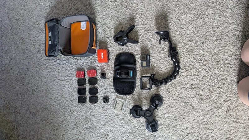 GoPro HERO7 Black camera kit with carrying case, mounts, and spare batteries