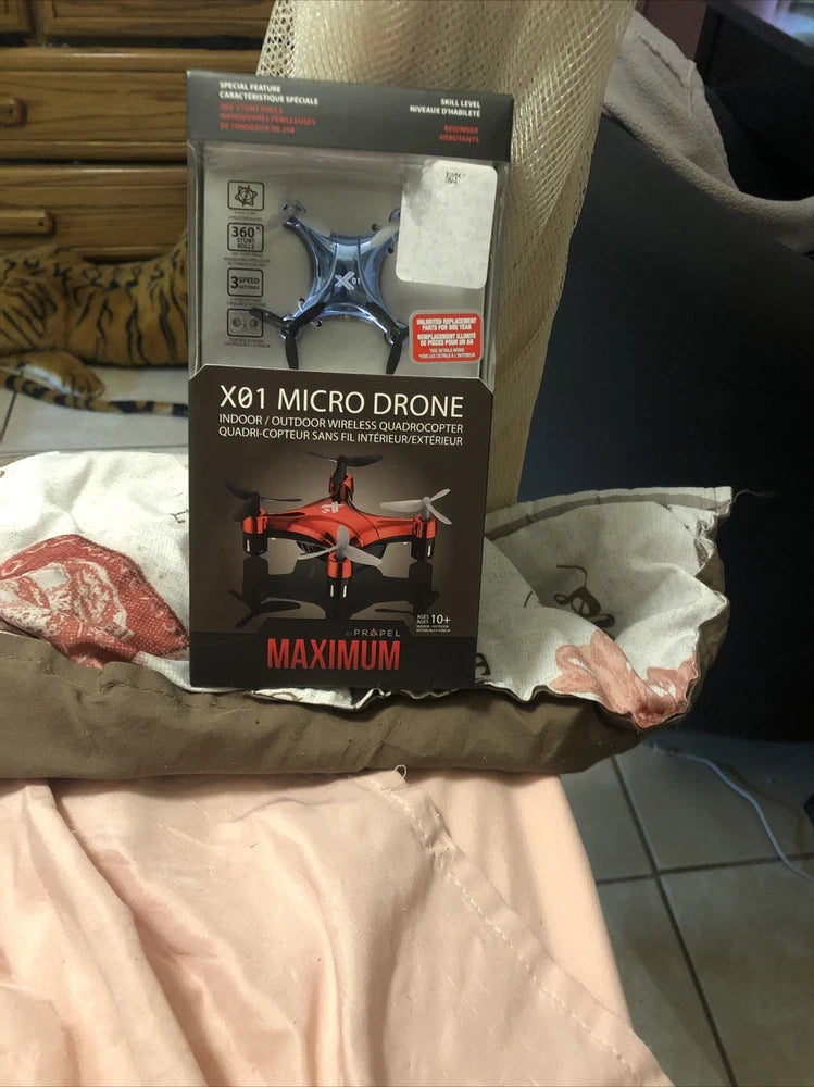 Micro drone retail box with star-shaped prop quadcopter illustration and accessory icons