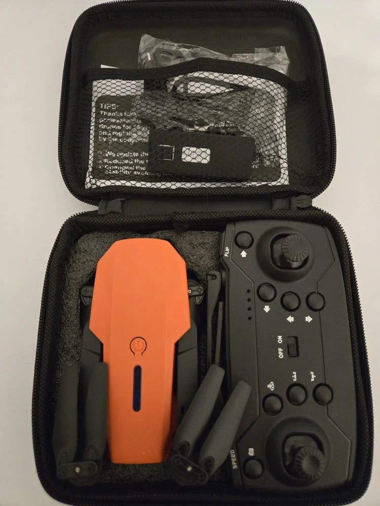 Small HD drone in black zip carrying case with orange drone body and accessories