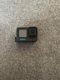 GoPro Hero12 Black action camera housing, front lens and status window visible