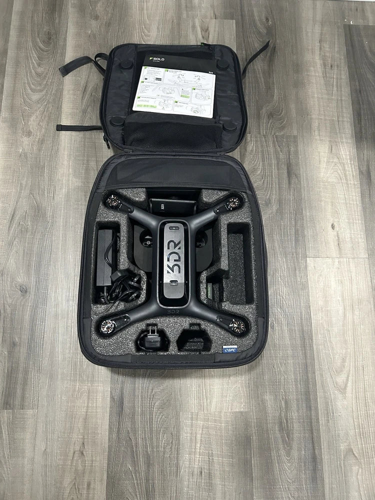 3DR Solo drone quadcopter in open black backpack case with compartments