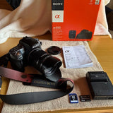 Sony Alpha 550 DSLR camera with zoom lens and Disney strap, memory cards