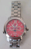 Red dial metal wristwatch with Roman numerals, chronograph subdials, and bracelet strap