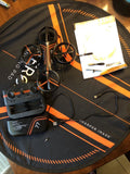 Sharper Image aero drone kit with controller, orange drone, and connecting cables