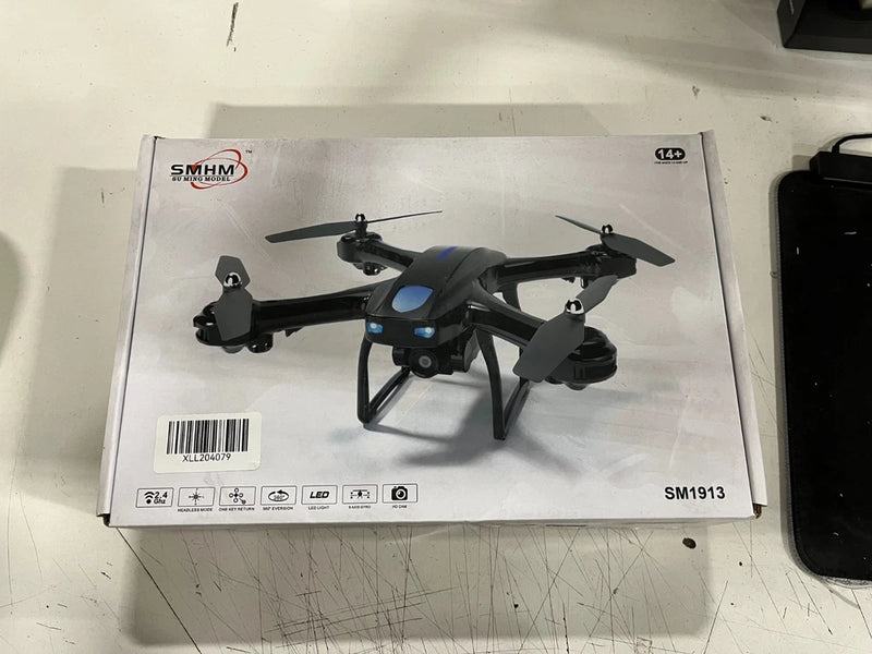 Foldable mini quadcopter drone with camera, blue accents, in SMHM box