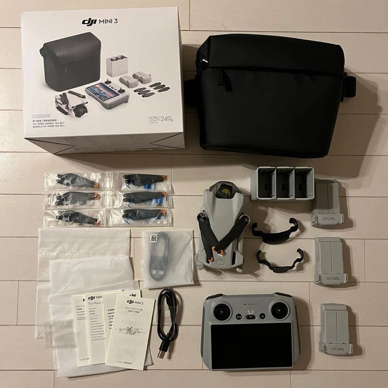 Drone accessories combo kit with remote controller, charging case, batteries, and manuals