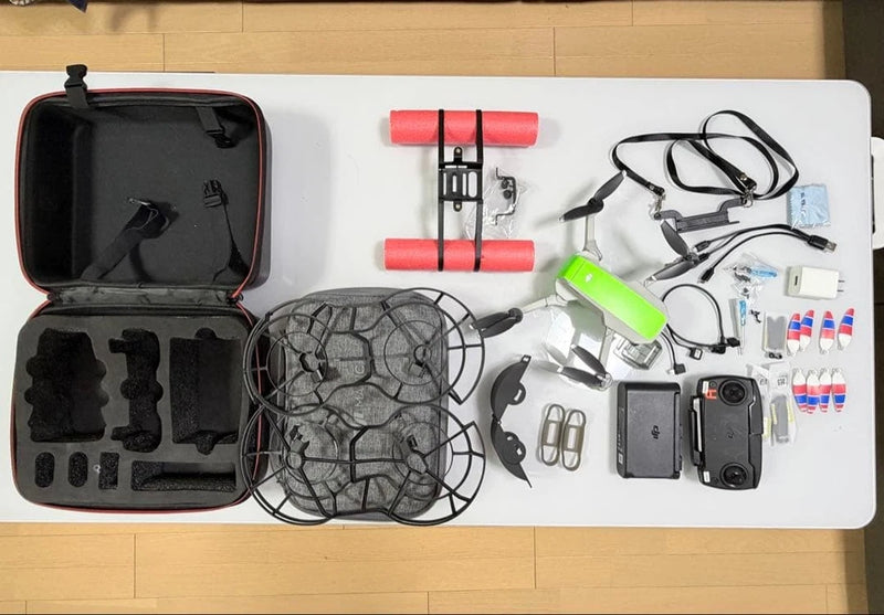 Compact drone accessories kit with case, prop guards, cables, and batteries
