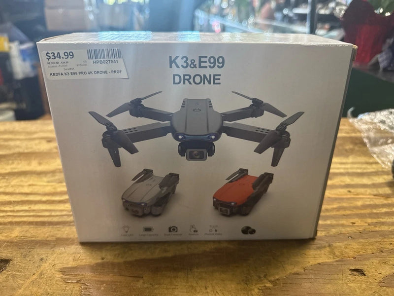 RC quadcopter drone retail box labeled K3&E99 with drone illustration