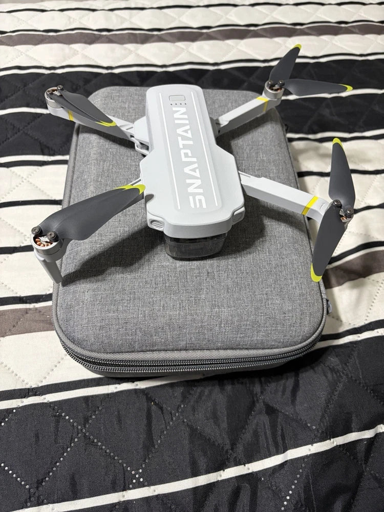 Gray 4K GPS drone with foldable rotors in a gray zippered carrying case