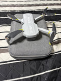 Gray 4K GPS drone with foldable rotors in a gray zippered carrying case