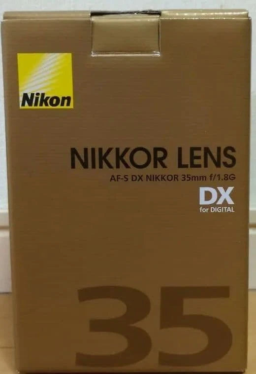 Nikon NIKKOR AF-S DX 35mm f/1.8G lens box with Nikon logo on brown packaging