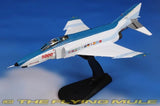 White F-4E Phantom II scale model on black display stand, side view.