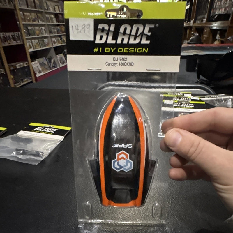Blade RC helicopter canopy in orange, black, and white, in retail blister packaging