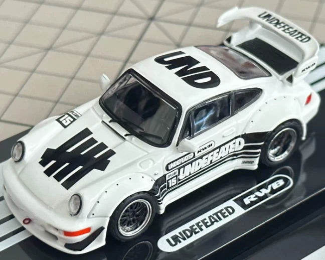 White die-cast model car with black racing decals and UNDEFEATED branding, side view