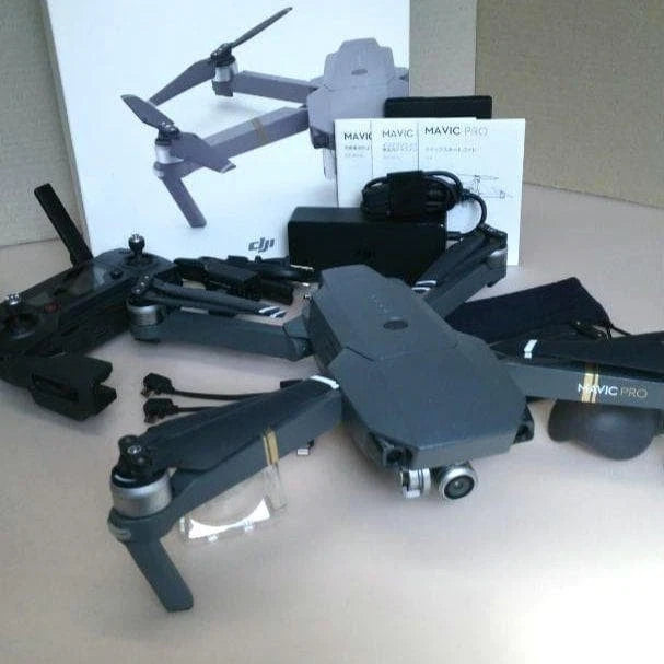 Foldable gray drone with remote controller, batteries, and propellers