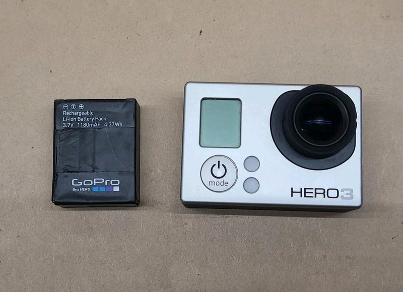 Silver HERO3 action camera with large lens, front buttons, and rechargeable battery pack