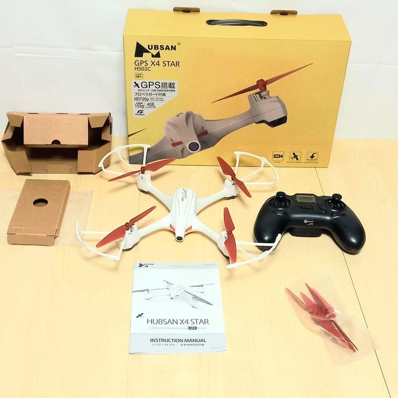 GPS quadcopter drone kit with remote controller, manuals, propellers, and packaging