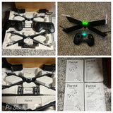 Black mini quadcopter drone with controller and instruction manuals
