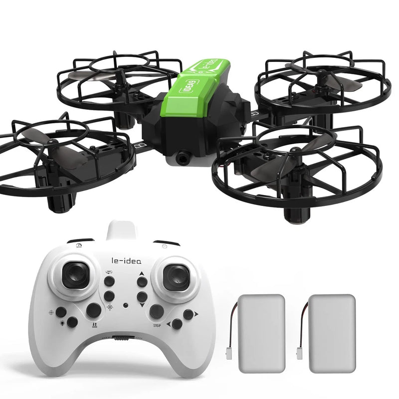 Mini green quadcopter drone with prop guards, white controller, and two spare batteries