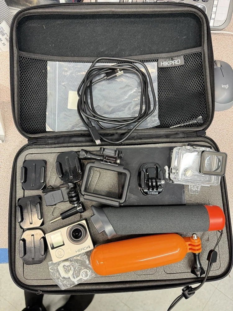 GoPro HERO4 action camcorder kit with mounts, orange float handle, and case