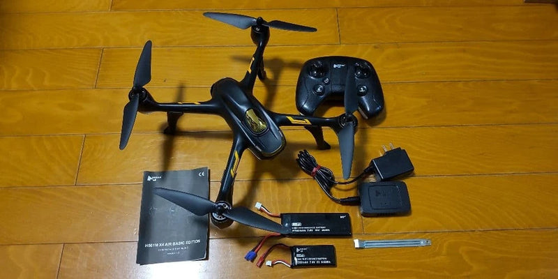 RC quadcopter drone with controller, FPV goggles, batteries, and charging cable