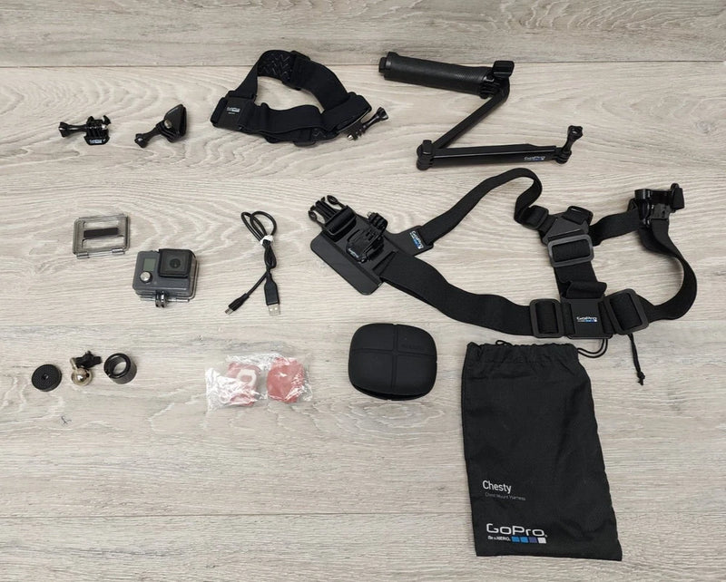 GoPro waterproof action camera bundle with chest harness, mounts, case, and handle