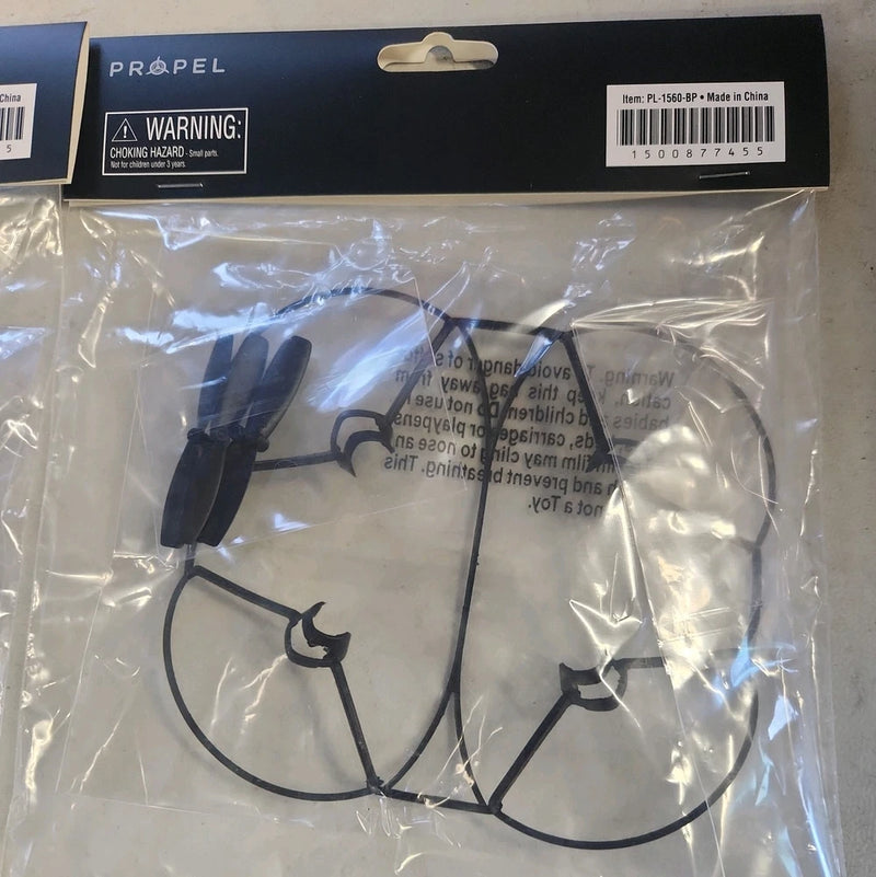 Black drone cage guard protector with four blades, in plastic packaging