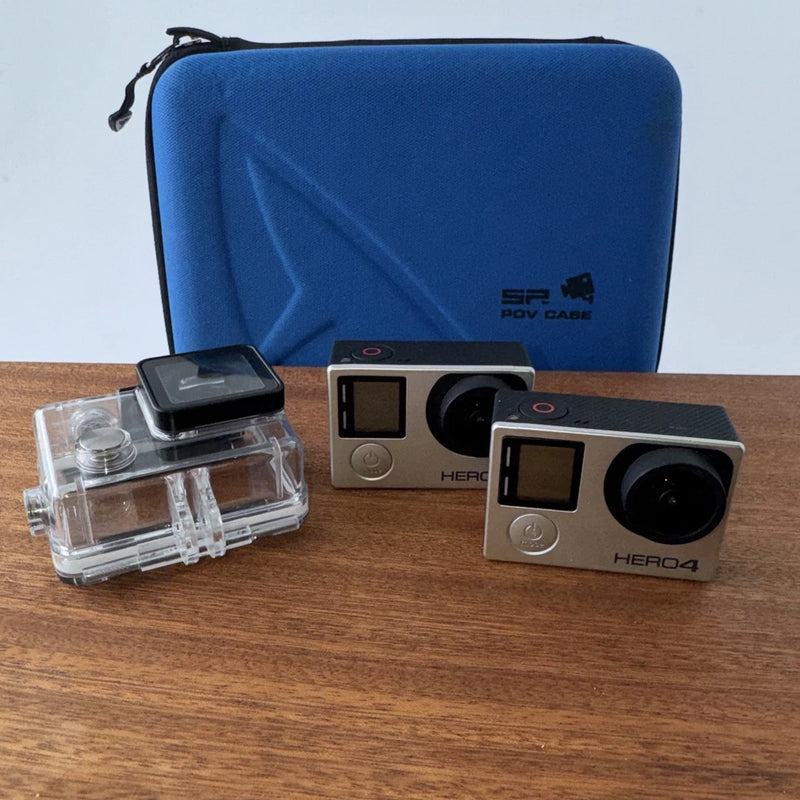 GoPro HERO4 action camera with waterproof housing, touch screen on front, and mounting accessories