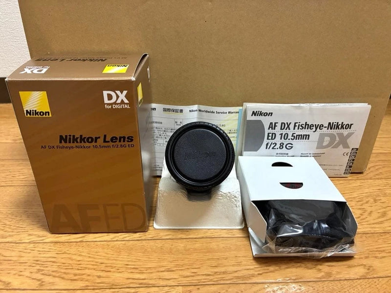 Nikon DX fisheye camera lens with black front cap and retail box