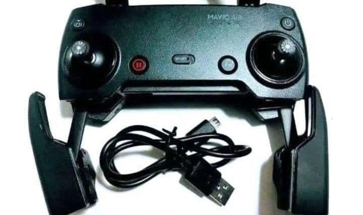 Drone controller with attached joysticks and USB charging cables