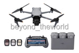 Foldable camera drone with controller and spare batteries, gray body