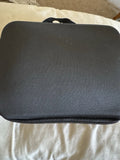 Black zippered soft drone carrying case with smooth top panel
