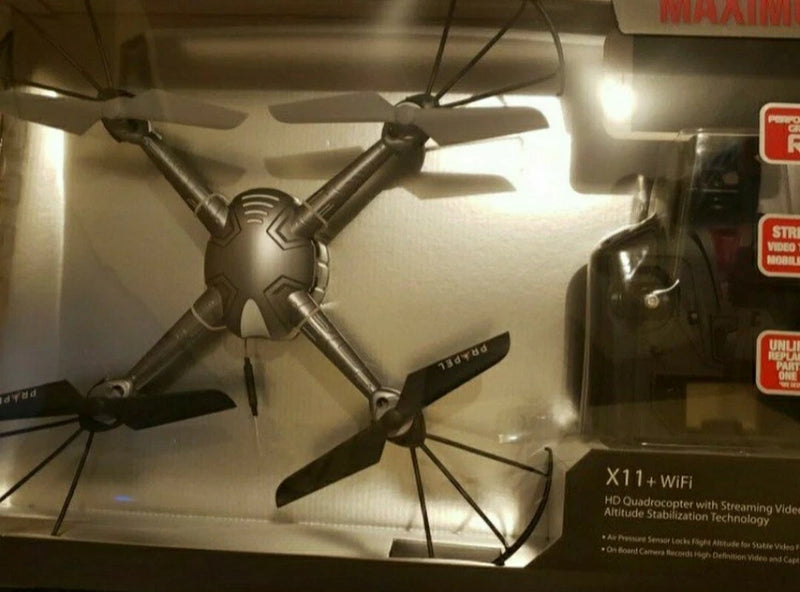 Dark quadcopter drone with four propellers, WiFi streaming module visible.