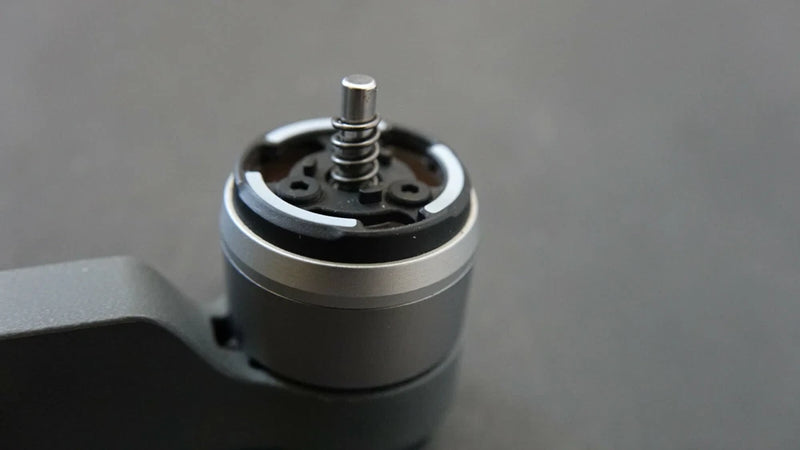 DJI drone rear left arm motor replacement, black and silver cylindrical DC motor