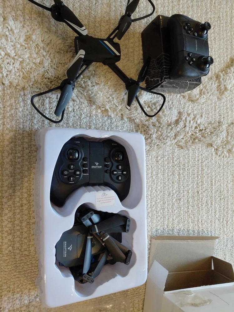 Protocol drone and remote controller set in molded white foam tray