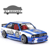 Blue and white racing die-cast model car with BBS wheels and BMW front grille